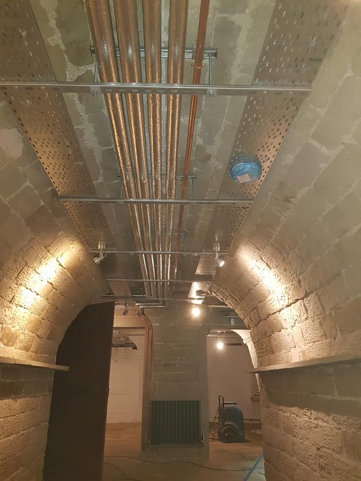 Vaulted cellar plant room with insulated copper distribution along the apex and perforated cable tray